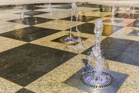 Decorative jet fountain on the square marbleの写真素材