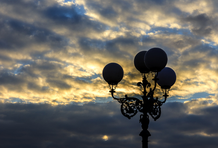 Street lamp on a background of a cloudy sunset skyの写真素材