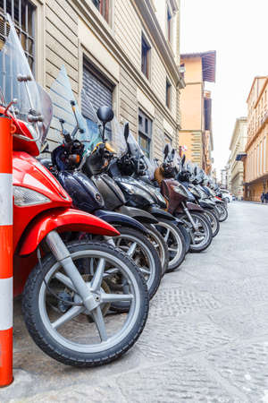 Motorbikes standing in the street in Florenceの写真素材