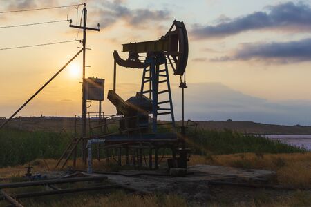 Oil rocking at sunsetの写真素材