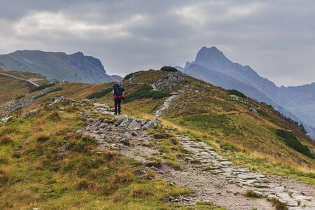 Hiker walking along a trail in the mountains