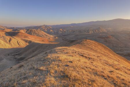 Photographer preparing to shoot in the mountains at sunset day
