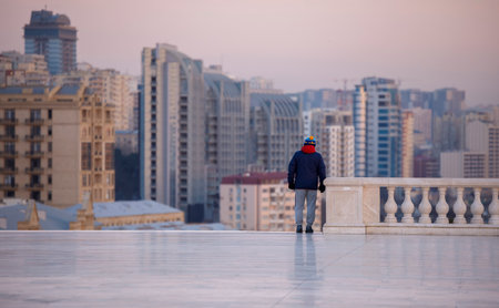 Baku, Azerbaijan, - December 26, 2019: Man in sportswear on the background of buildingsのeditorial素材