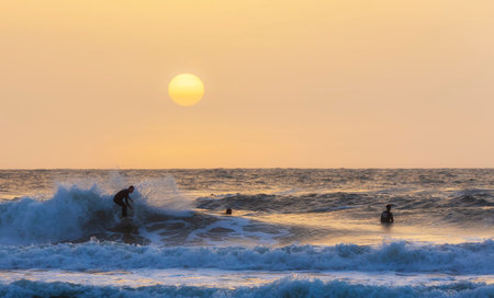 Herzliya, Israel - March 05, 2020: Surfer rides the waves of the Mediterranean Sea