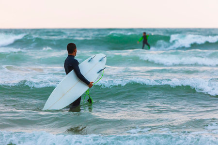Herzliya, Israel - March 05, 2020: Surfer rides the waves of the Mediterranean Seaのeditorial素材