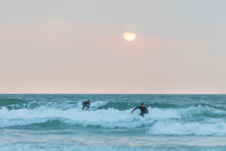 Herzliya, Israel - January 05, 2020: Surfer rides the waves of the Mediterranean Seaのeditorial素材