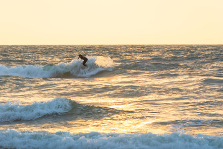 Herzliya, Israel - March 05, 2020: Surfer rides the waves of the Mediterranean Seaのeditorial素材