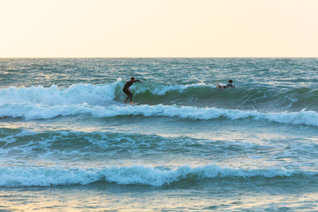 Herzliya, Israel - March 05, 2020: Surfer rides the waves of the Mediterranean Seaのeditorial素材