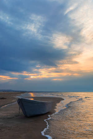 Fishing boat on the coast of the beachの写真素材