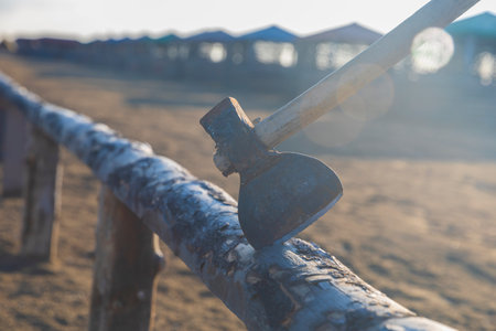 Old rusty ax stuck in a logの写真素材