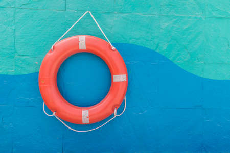 Lifebuoy hanging on a colorful wall