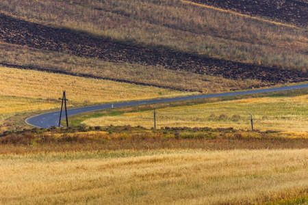 Asphalt road passing through the fields