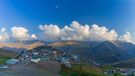 The alpine village of Khinalig at sunset against the backdrop of beautiful cloudsの写真素材
