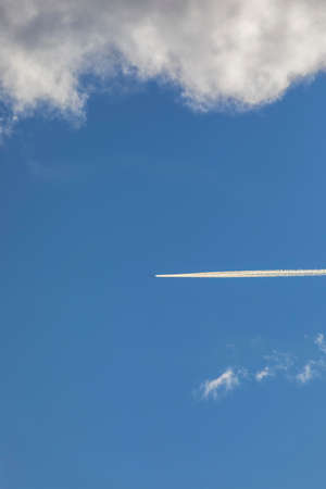 Trail from a flying plane over snow-capped mountainsの写真素材
