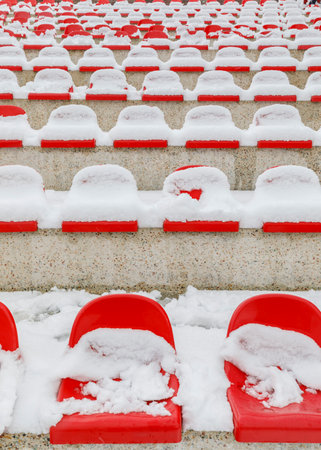 Stadium seats covered with snow in Januaryの写真素材