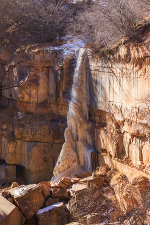 Frozen waterfall in the mountainsの写真素材