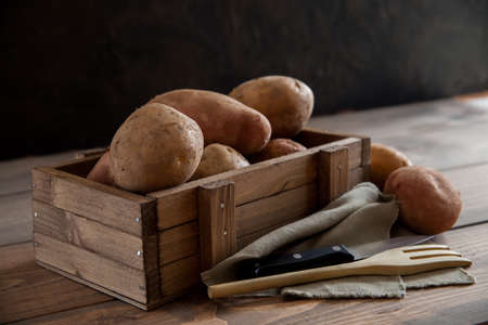 Box with raw potatoesの写真素材