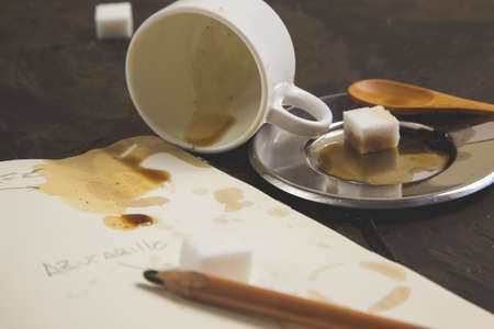 A cup of coffee and a stained bookの写真素材