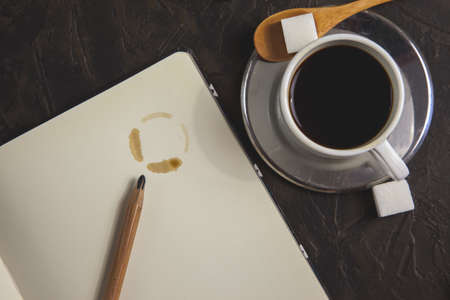 cup of coffee and coffee stain on paper