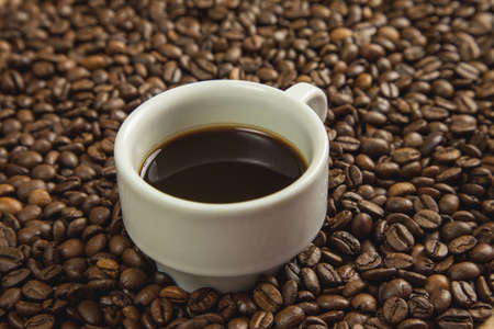 Cup of coffee in the morning with coffee beansの写真素材