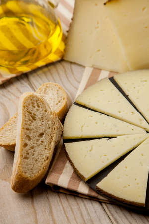 Plate with slices of cured Manchego cheese. ready to eatの写真素材