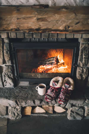 Christmas comfortable slippers by the warm cozy fireplace.の写真素材