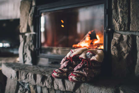 Christmas comfortable slippers by the warm cozy fireplace.