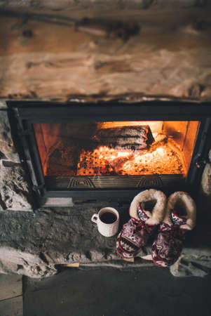 Christmas comfortable slippers by the warm cozy fireplace.の写真素材