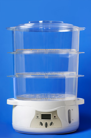 Multi-Tier Food Steamer isolated on blue backgroundの写真素材