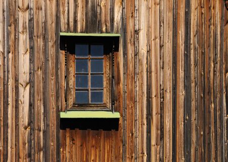 Old wooden building close up of a wall with a windowの写真素材