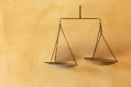 Old rusty scales hanging on a wallの写真素材