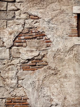 Old rustic stone and brick wall, grungy texture backgroundの写真素材