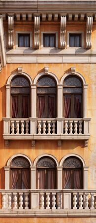 Arched windows of a house texture. Venetian gothic architectural style.の写真素材