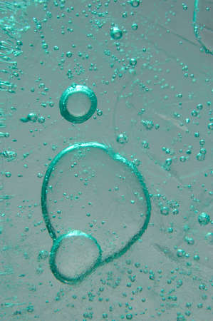 Ice with bubbles of air abstract light green blue macro background texture