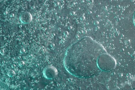 Ice with bubbles of air abstract light green blue macro background textureの写真素材