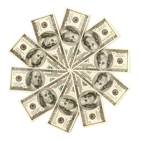 Artistic pattern made from dollar bills Snowflake or star Isolated with a clipping path on white backgroundの写真素材