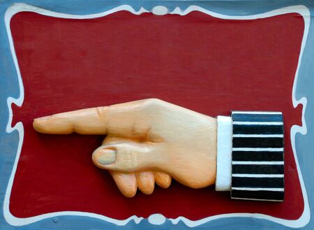 Decorative sign with hand pointing the directionの写真素材