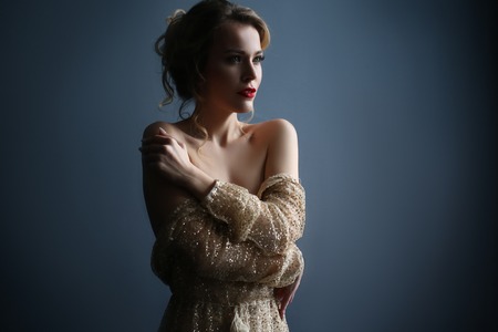 Sexy blonde in transparent dress with golden rhinestonesの写真素材