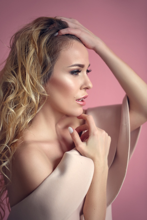 Portrait of a blonde in the dress with a plantの写真素材