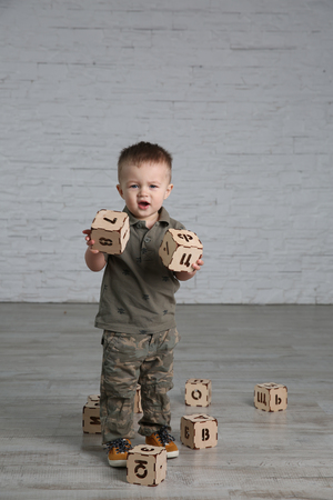 Child boy playing in the room with letter toy blocksの写真素材