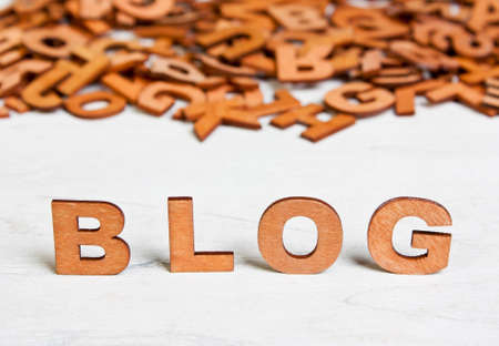 Word Blog made with wooden letters on a background of other blurred lettersの写真素材