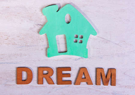 green house and the word dream of letters on a white wooden backgroundの写真素材