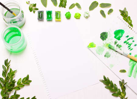 Green leaves draws the artist. Concept art. Workplace, designer table.Flat lay, overhead viewの写真素材