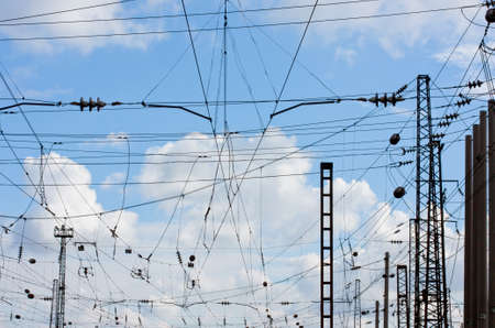 power line against the blue sky with white clouds at the railway station.Power Line against sky background.X-ray effect.の写真素材