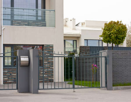 Cottage house behind the fence. Modern exterior of home.Modern stylish facadeの写真素材