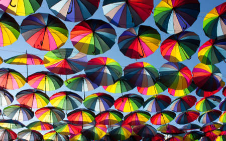 Multi-colored umbrellas in the sky.Umbrellas rainbow colors