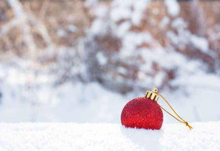 Christmas red toy in the snow. Concept of winter, holiday, New Yearの写真素材