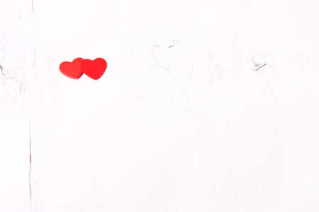 two red wooden heart on a white background wooden backgroundの写真素材