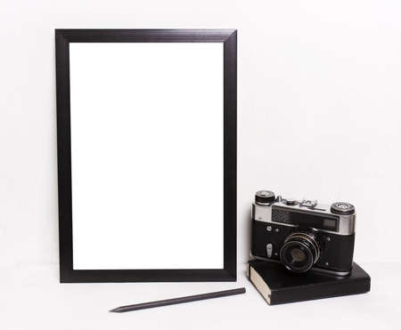 Blank black picture frames on on  white background ,Vintage camera, notebook. Mockup in hipster style workspaceの写真素材