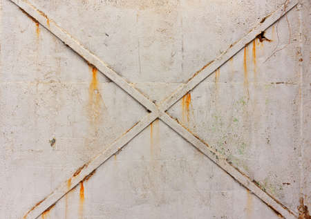 Cross on metal doors, a background of gray, cracked paint, iron texture and rustの写真素材